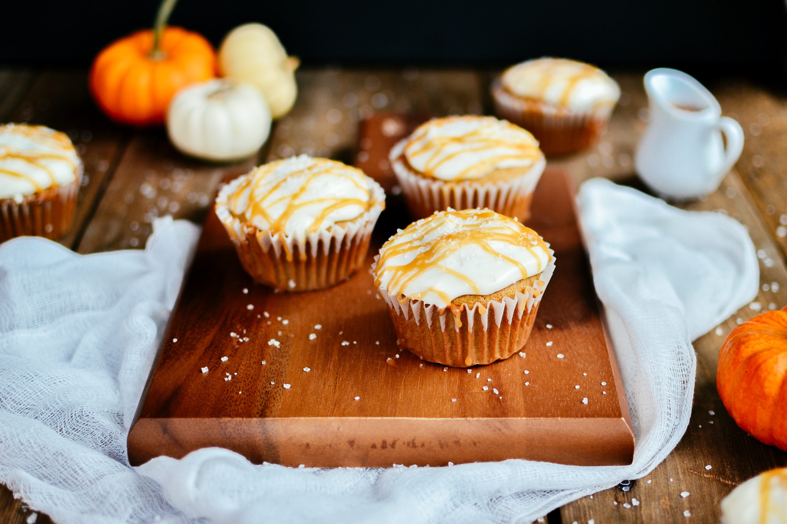 pumpkin spice cupcakes with cream cheese icing and salted caramel drizzle
